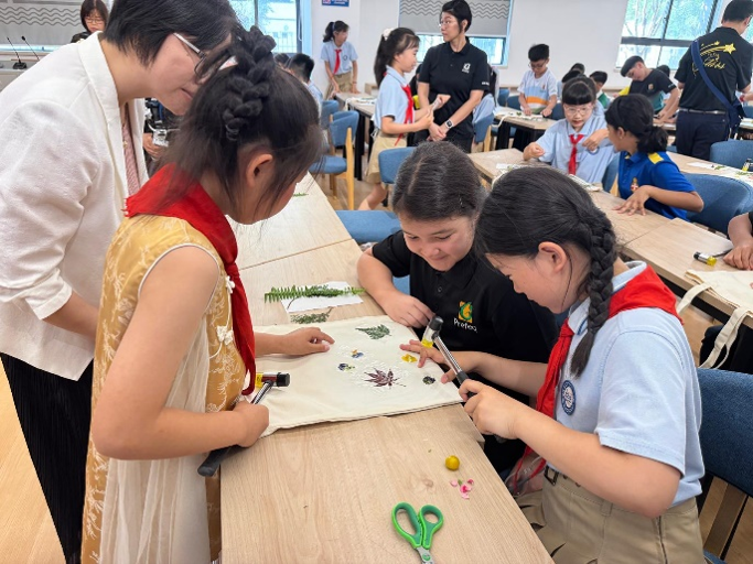 Students taking part in a cultural craft workshop with visiting facilitators.